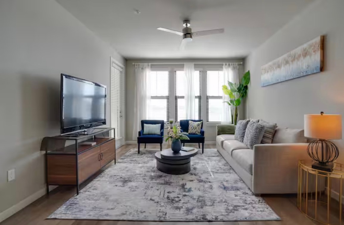 Modern furnished living room with navy accent chairs
