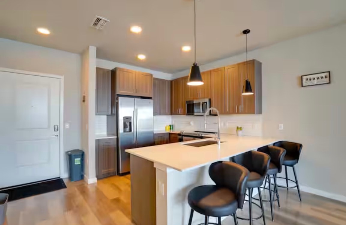 Modern kitchen with island seating and stainless appliances