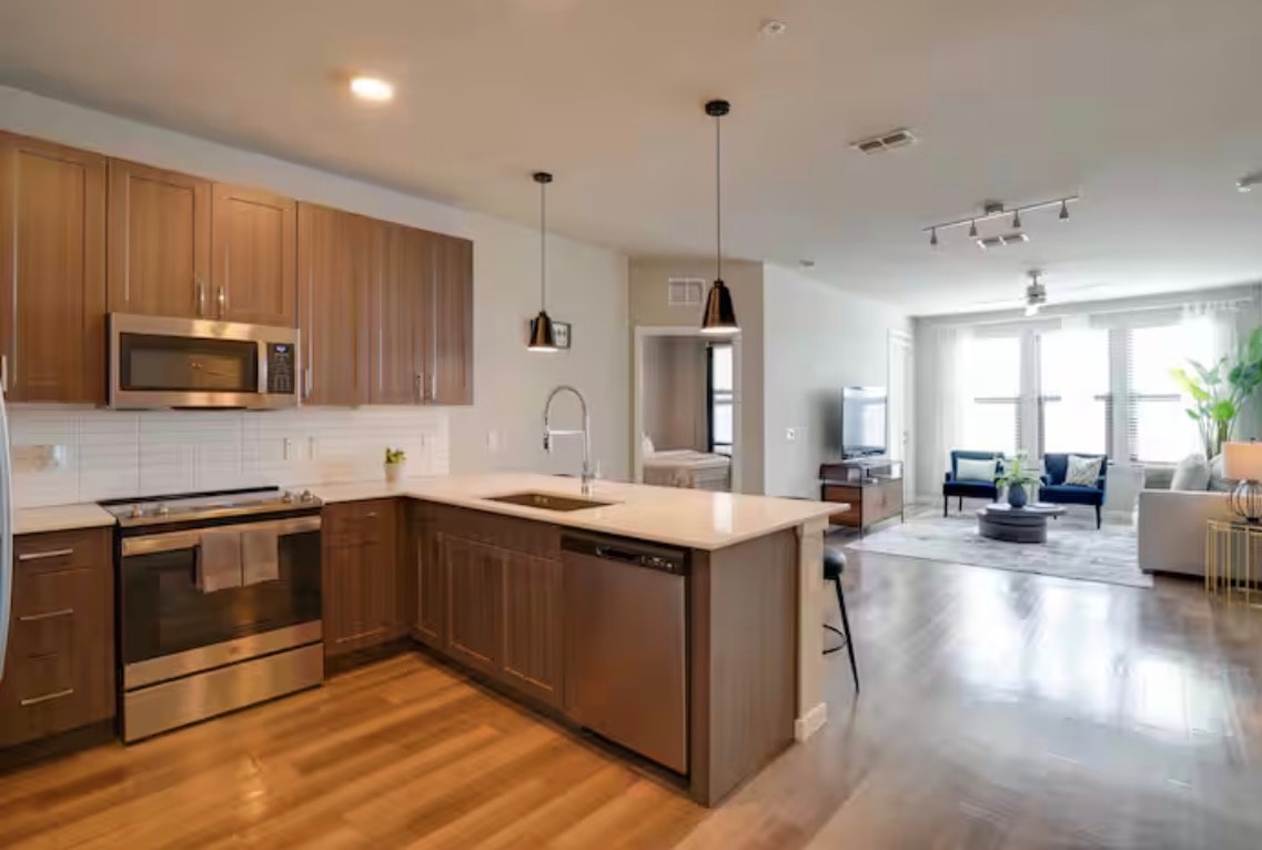 Kitchen and living space with warm wood cabinetry