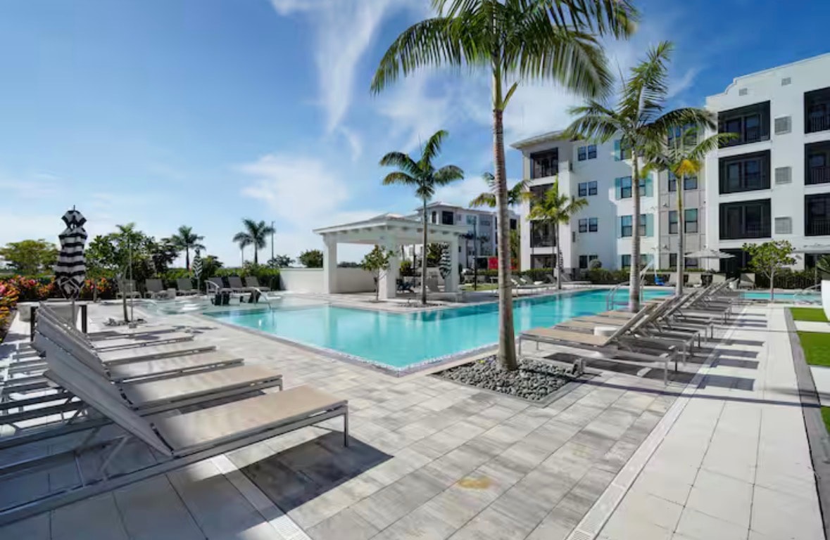 Resort-style community pool with palm trees